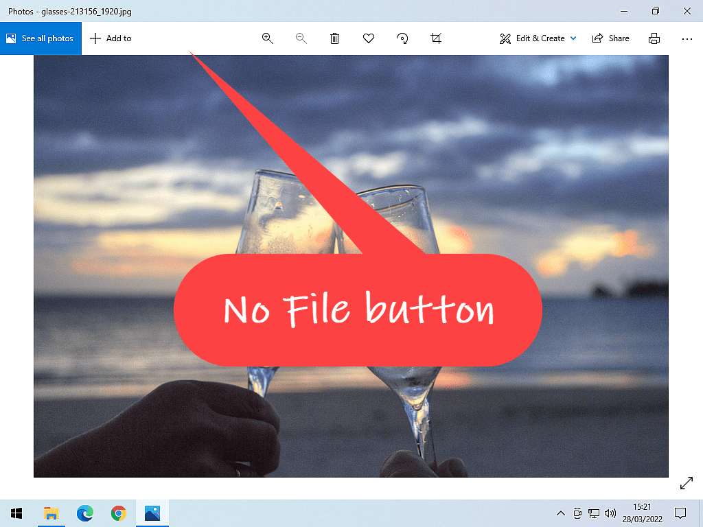 Windows 10 photos app is open. Callout points out there isn't a File button to click on.