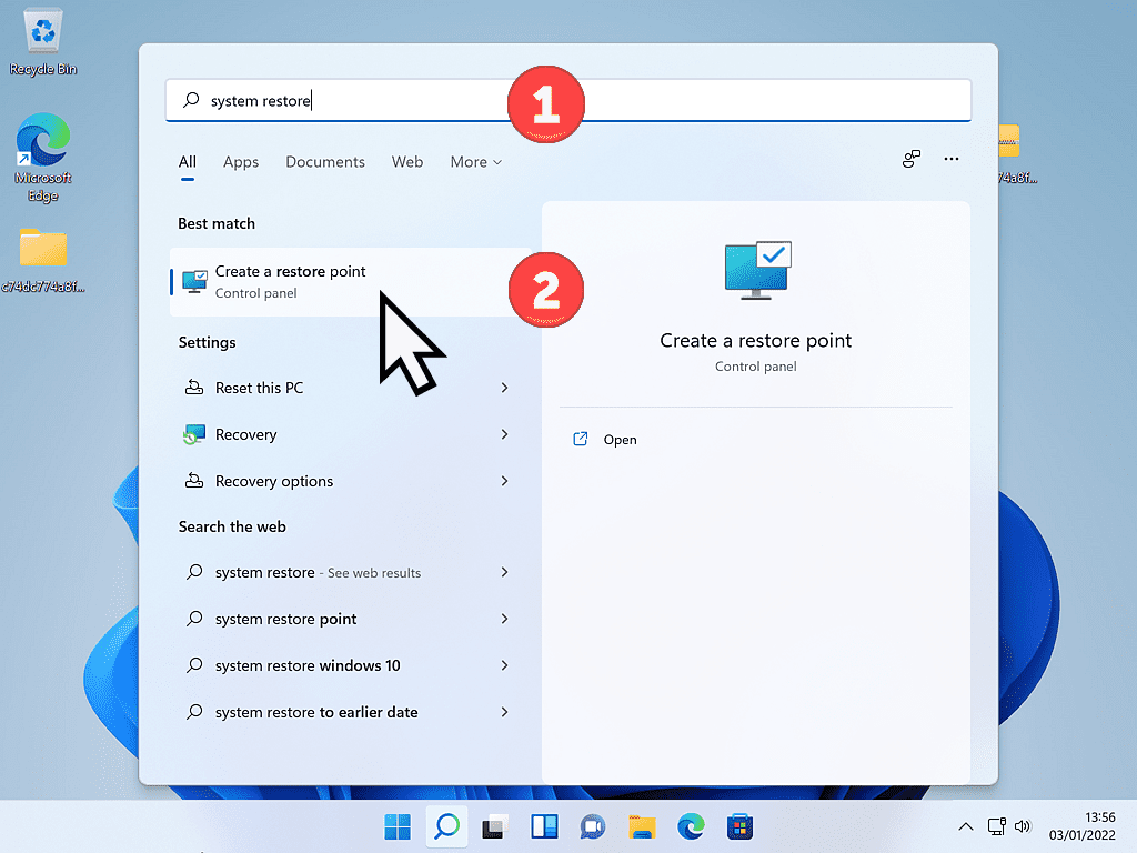 System restore has been entered into the search box in Windows 11. "Create a restore point" is marked in the search results.