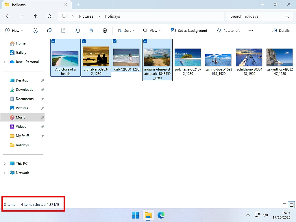 Item check boxes turned on in Windows 11 File Explorer with four photos ticked and 4 items selected shown at the bottom