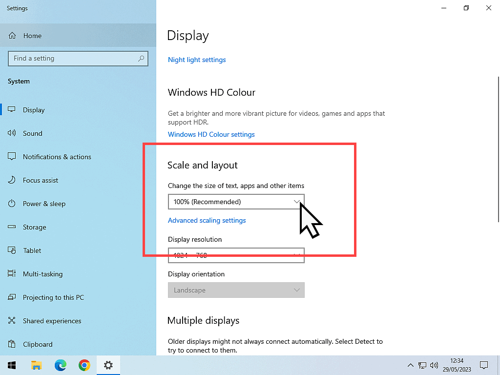 Scale and Layout section highlighted in Windows 10 and the dropdown arrow is marked.